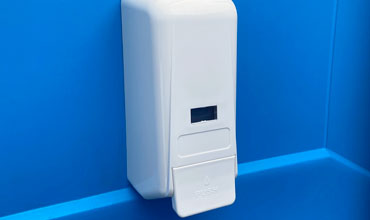 Alcohol hand sanitiser dispenser fitted to a portaloo